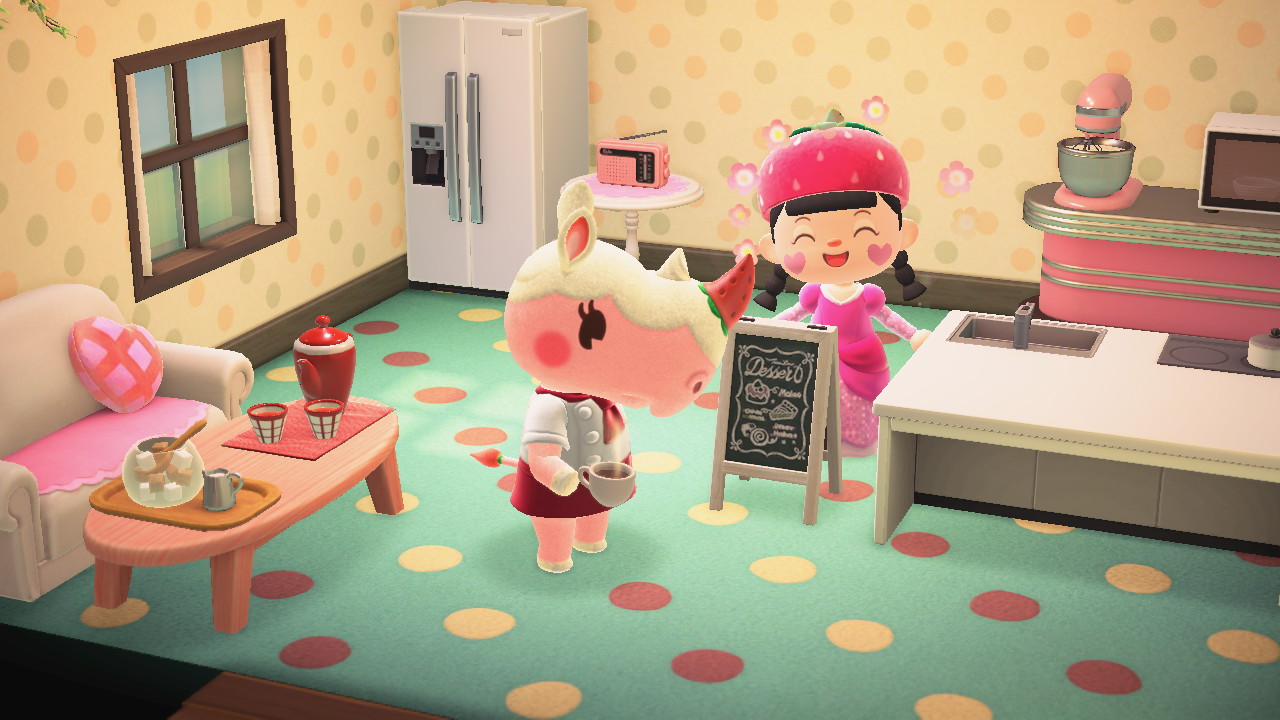 A bright interior with polka dot walls and floor and pink kitchen themed items